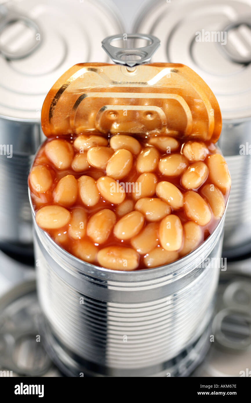 TIN FOOD CANS STACKED WITH ONE CAN OPEN FILLED BAKED BEANS IN TOMATO SAUCE TIN FOOD CANS STACKED WITH ONE CAN OPEN FILLED BAKED BEANS IN TOMATO SAUCE