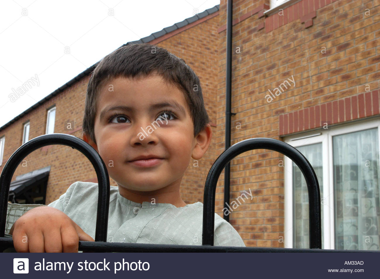 Download preview image - small-boy-playing-outside-his-housing-association-home-halifax-yorkshire-AM33AD