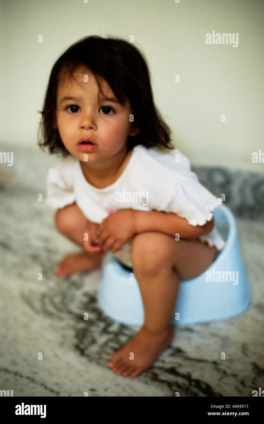 Portrait of a two year old girl on the potty just after waking up Stock