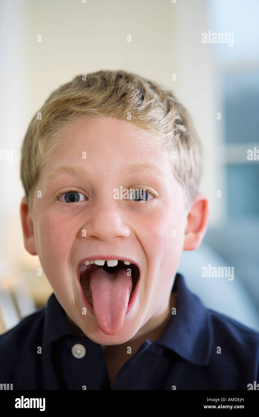 Portrait of a boy sticking out tongue Stock Photo, Royalty Free Image