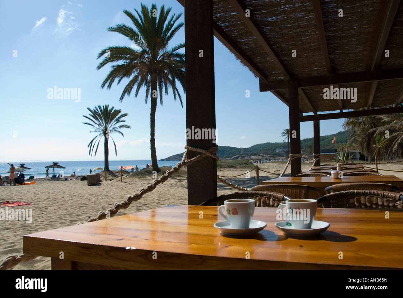 coffee cups on a wooden table in a beach cafe, overlooking the coffee cups on a wooden table in a beach cafe, overlooking the