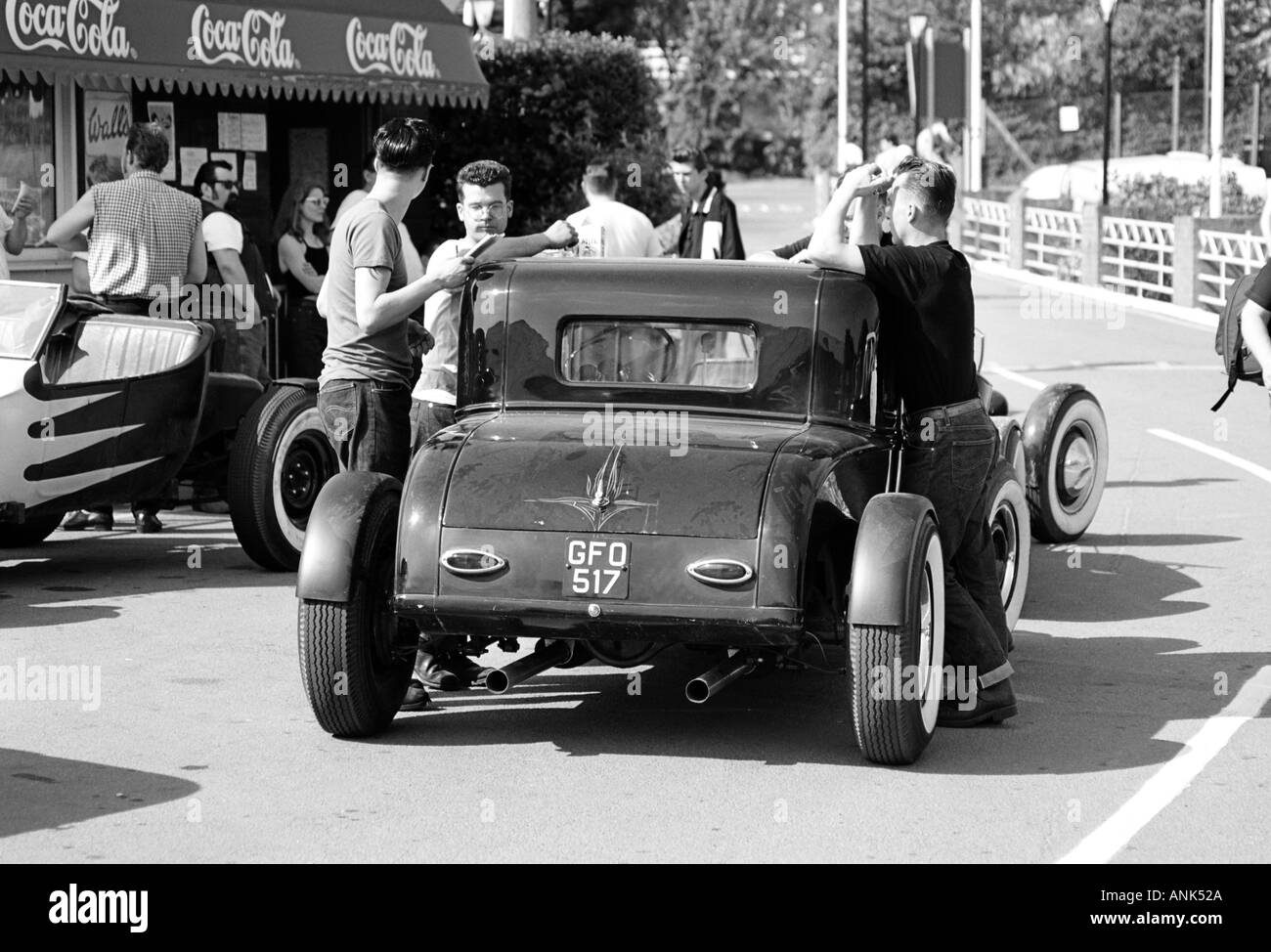 "Greasers" lean on their 1950s street rod at Hemsby rock 'n' roll Stock