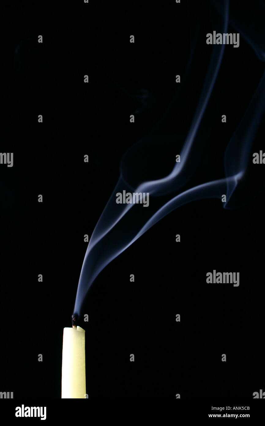 Recently Extinguished Smoking Candle Against Black Background