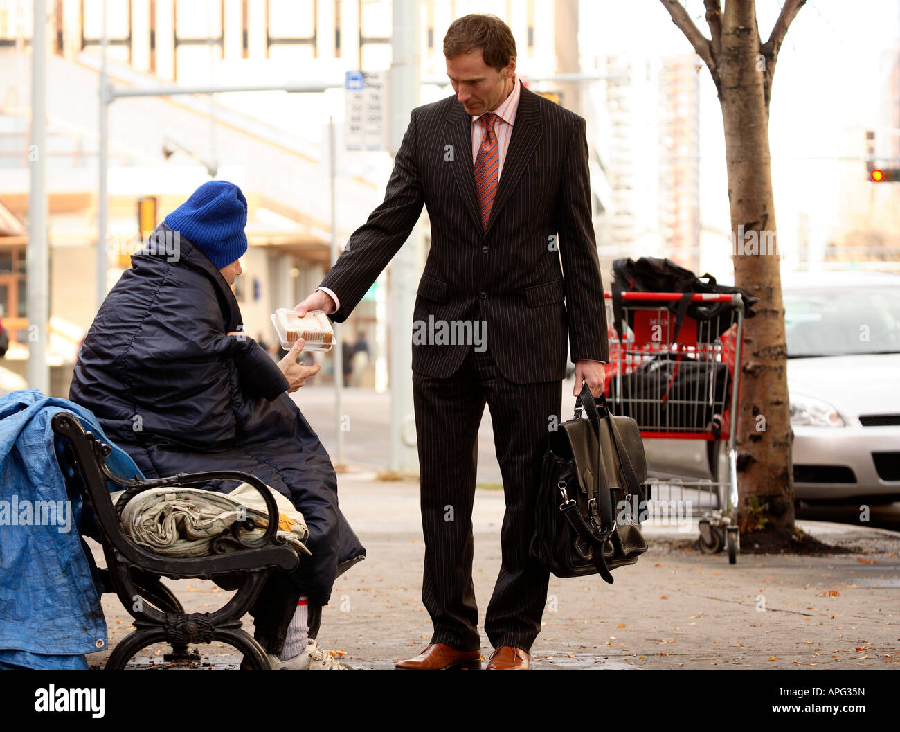 Businessman giving food to homeless man Stock Photo, Royalty Free Image 15781424 Alamy