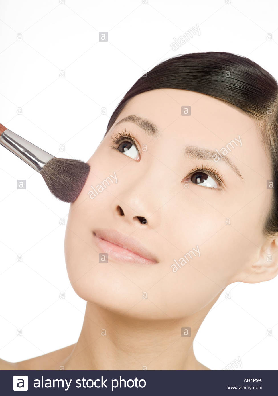 Chinese woman applying blusher Stock Photo, Royalty Free Image