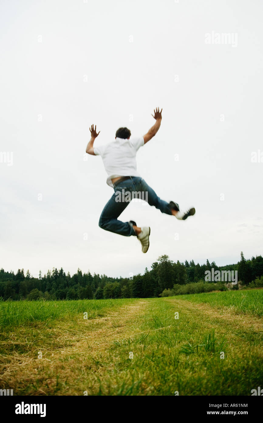 Man Jumping In Field Stock Photo Alamy