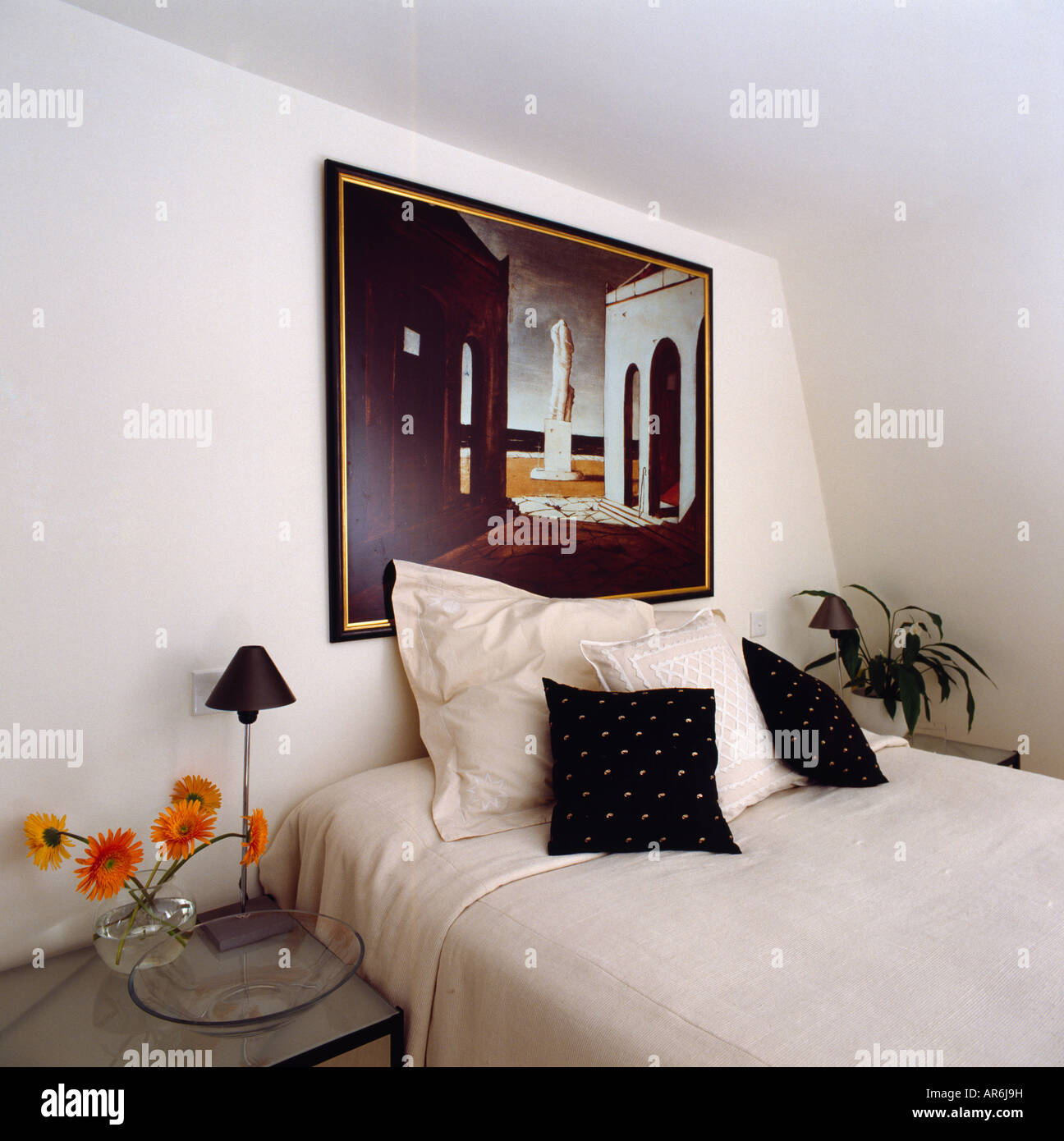 Modern Painting Above Bed With White Linen And Black Cushions In Attic Bedroom Modern Painting Above Bed With White Linen And Black Cushions In Attic Bedroom