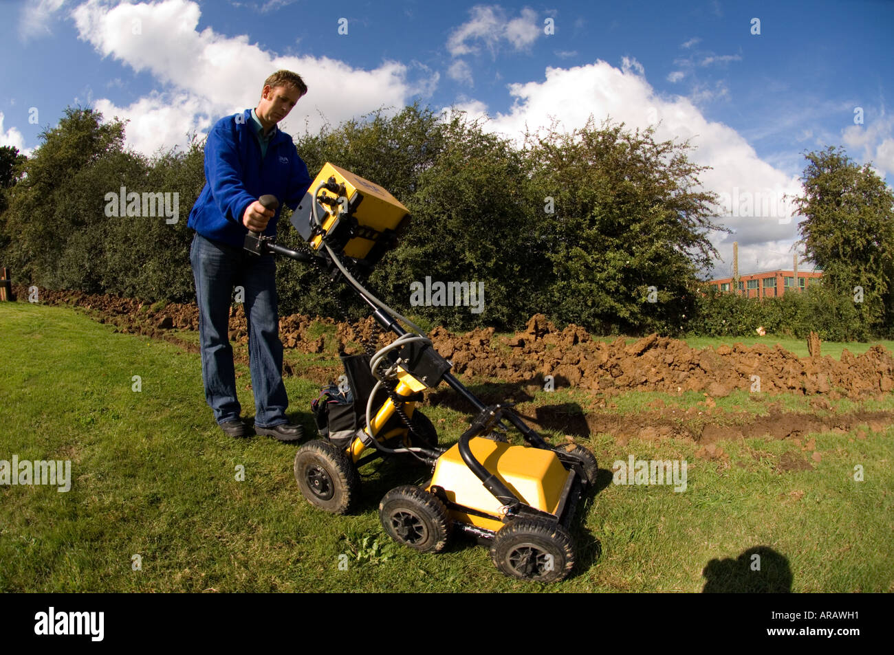Trained technician operating geophysics machine ground
