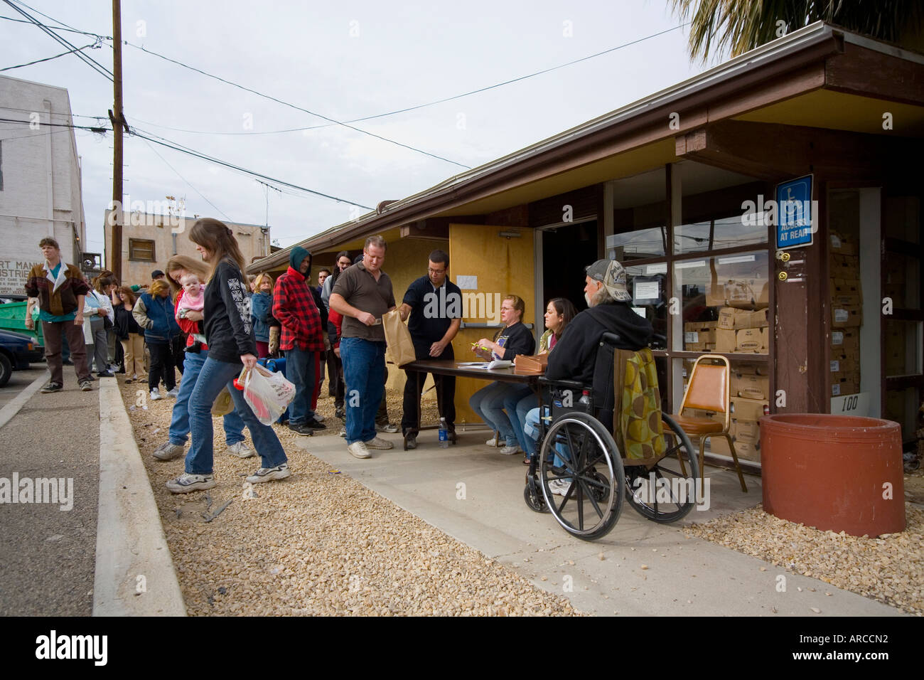 Low and homeless people line up at a Barstow CA homeless Stock