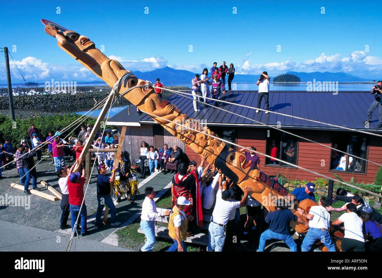 NATIVE AMERICAN TSIMSHIAN TRIBE RAISING A TOTEM POLE AT METLAKATLA