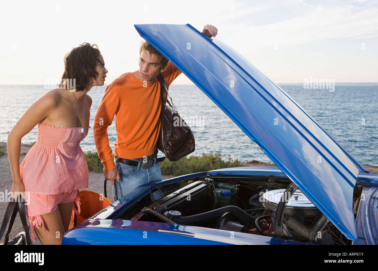 Man And Woman Looking Under Car Bonnet Stock Photo Alamy