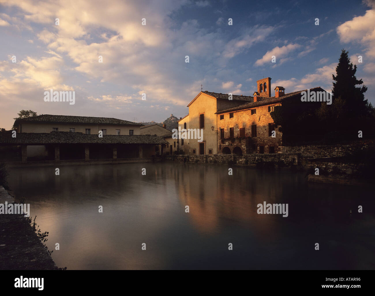 Historical Therm Bagno Vignoni at dawn with Rocca d\'Orcia in the ... Historical Therm Bagno Vignoni at dawn with Rocca d\'Orcia in the ...