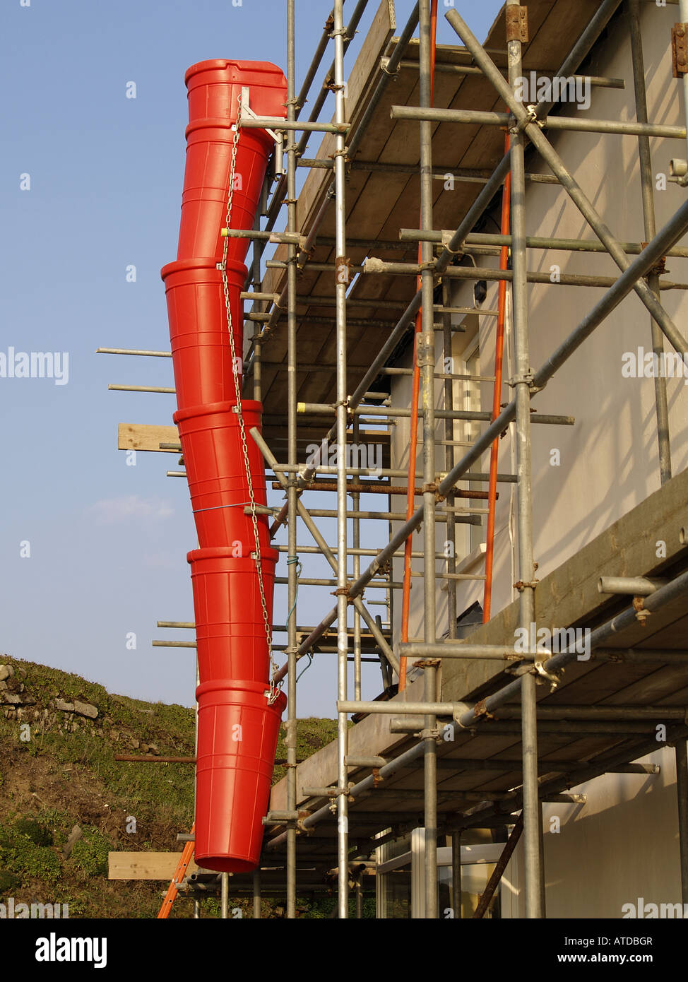 Scaffolding with red rubbish chute Stock Photo, Royalty Free Image