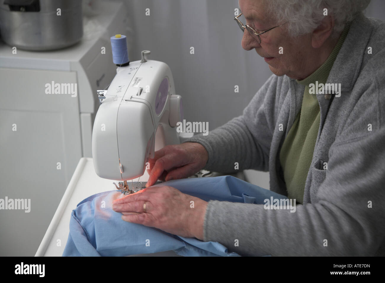 Elderly Woman Working At Sewing Machine Stock Photo Alamy