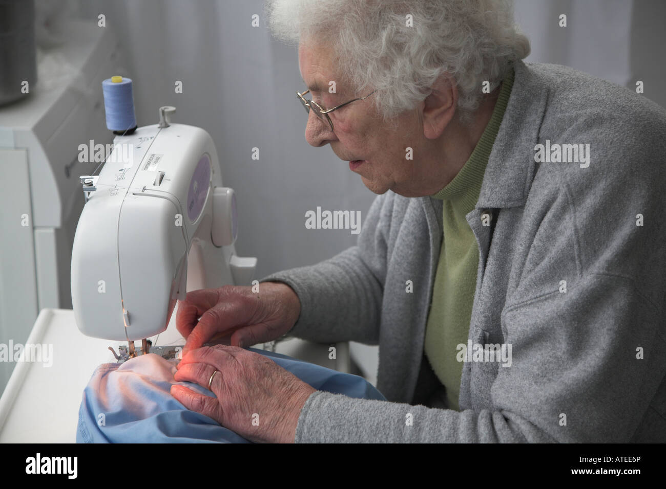 Elderly woman working at sewing machine Stock Photo, Royalty Free Image
