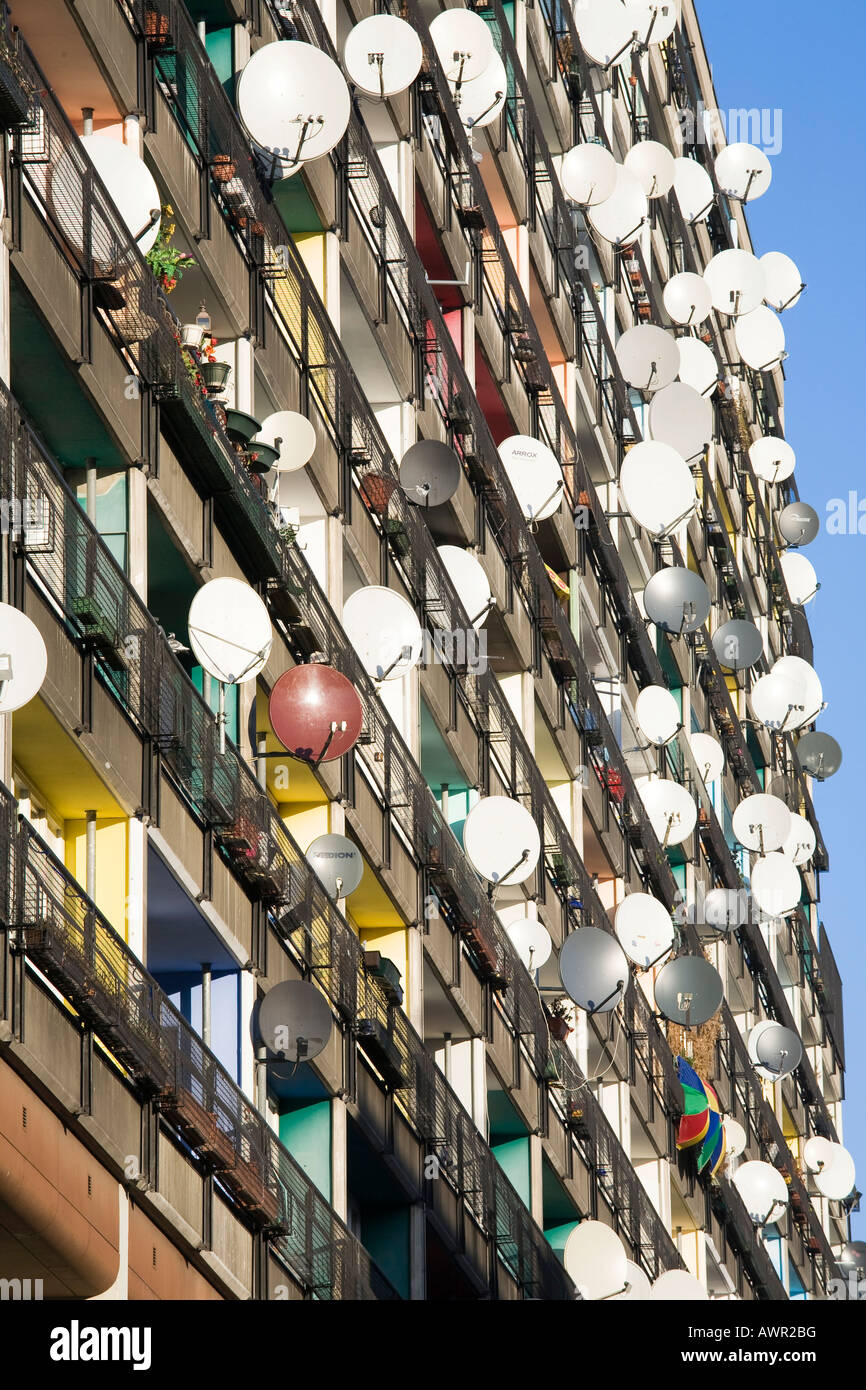 Lots of satellite dishes mounted to balconies on an apartment Stock
