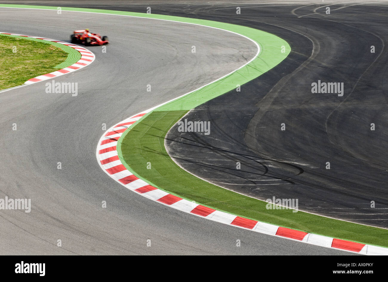 Formula 1 Racecar speeds through double bend curve in racetrack Stock