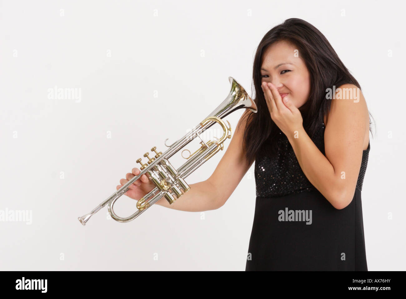 Stock Photograph of a Asian girl laughing while playing with a Stock Photo, Royalty 
