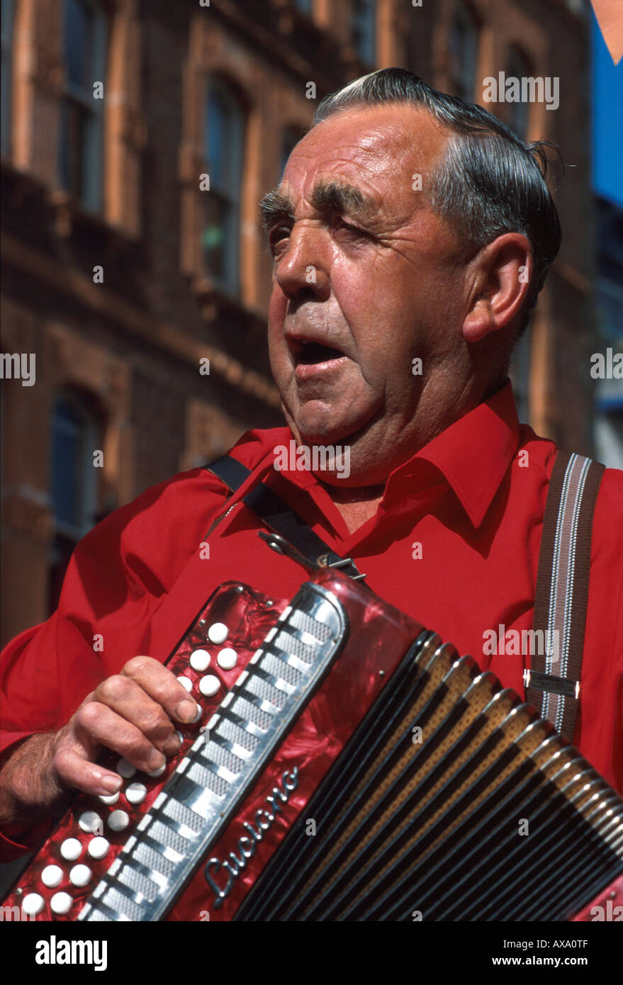 Old musician with accordion, St. <b>Peter Port</b>, Guernsey, Channel Islands, UK - old-musician-with-accordion-st-peter-port-guernsey-channel-islands-AXA0TF