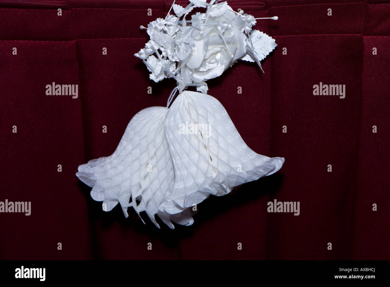 Paper Wedding Bells On A Maroon Background Paper Wedding Bells On A Maroon Background