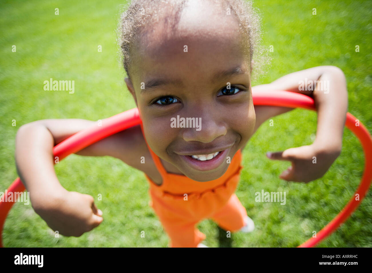 Girl playing with <b>hula hoop</b> Stock Photo - girl-playing-with-hula-hoop-AXRRHC