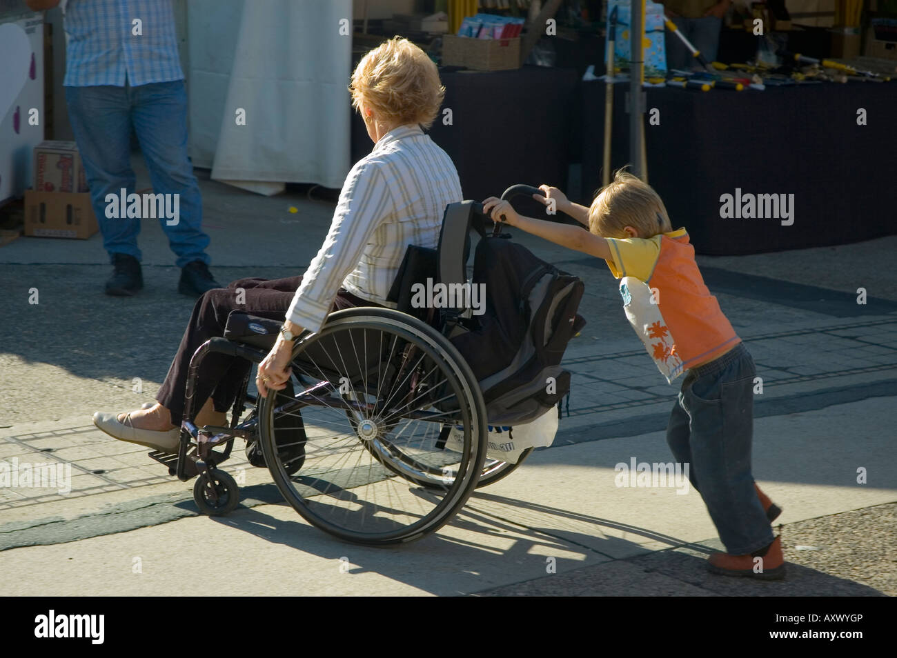 young boy pushing wheelchair Stock Photo, Royalty Free Image 16927989