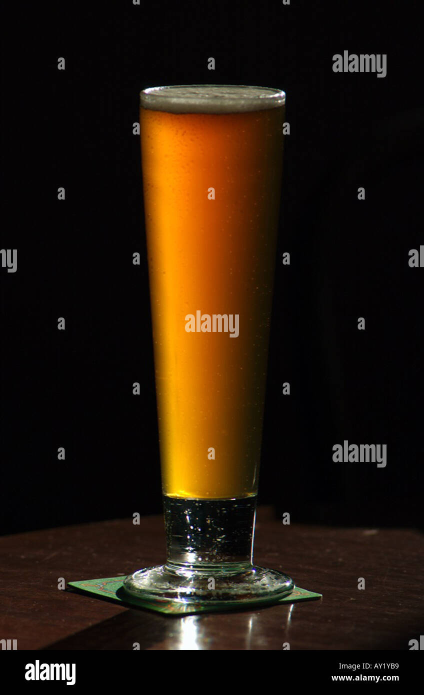 Tall Glass Of Beer With Froth And Foam On The Table In A Cafe Stock