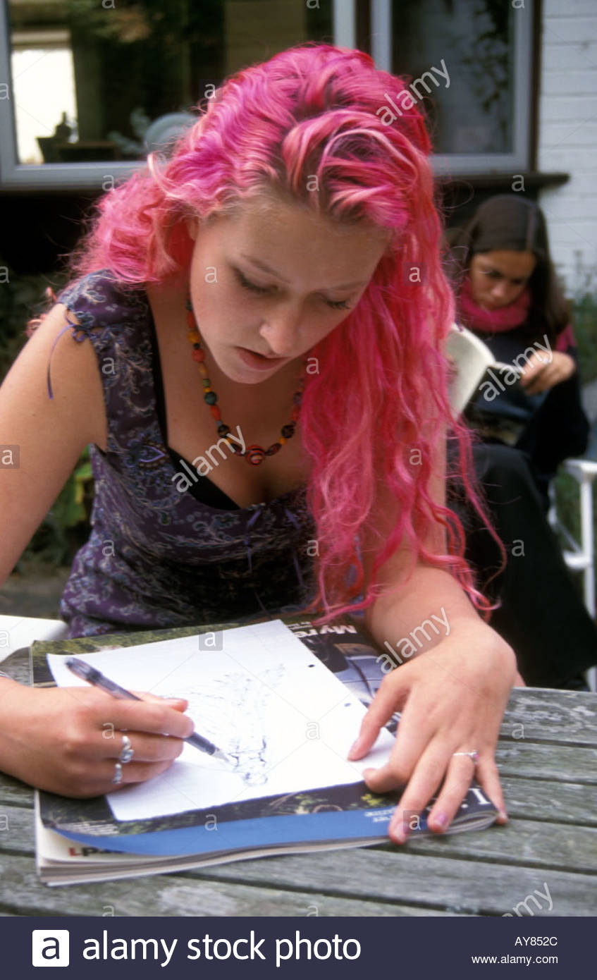 16 Year Old Girl With Dyed Pink Hair Sketching A Fashion Drawing