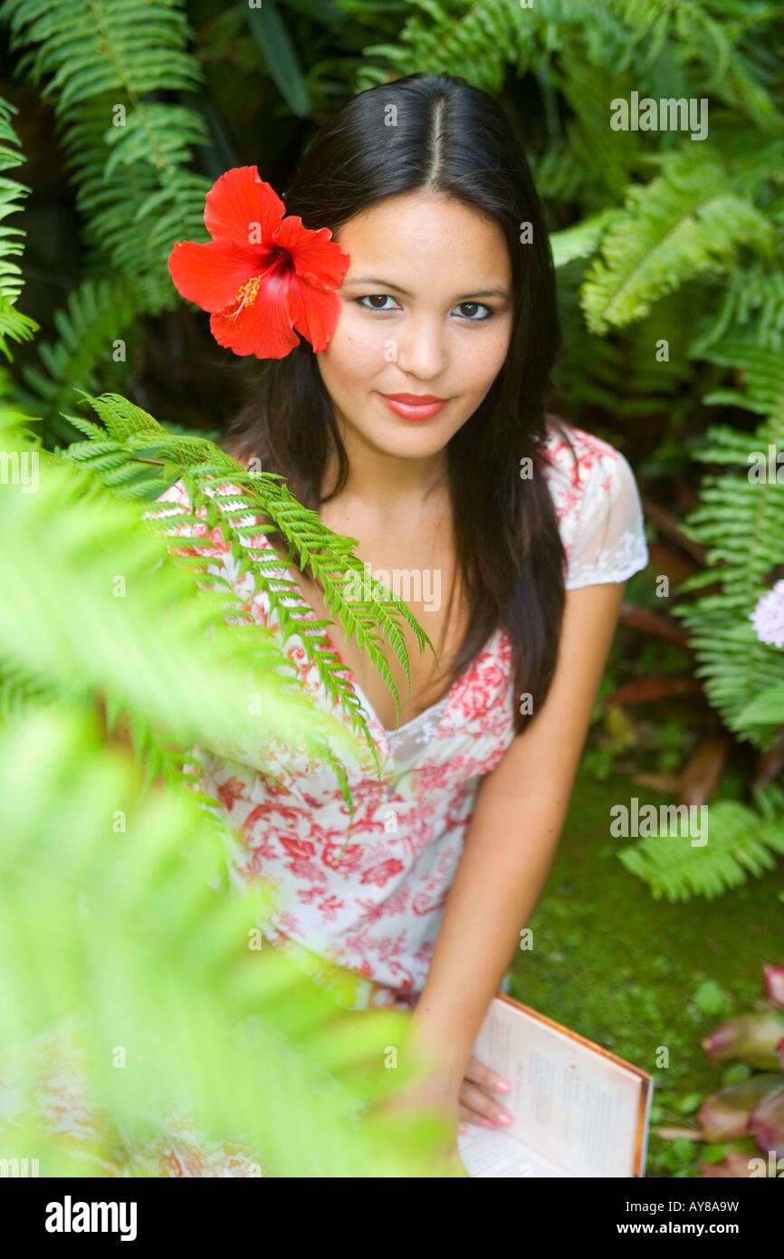 a-beautiful-young-polynesian-woman-in-her-fern-garden-in-hawaii-AY8A9W.jpg