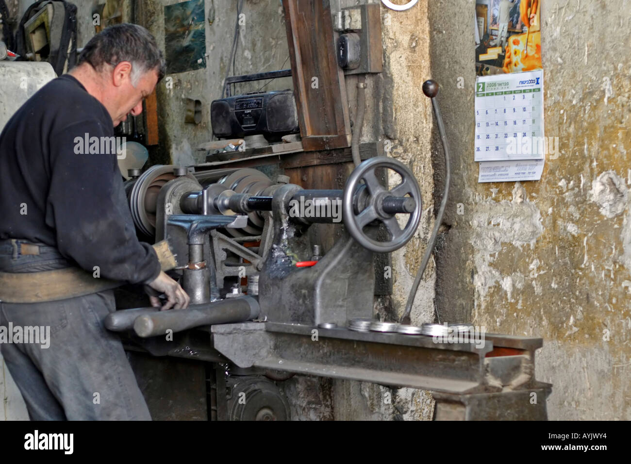 A man working on a lathe in a metal work shop Jaffa Israel Stock Photo