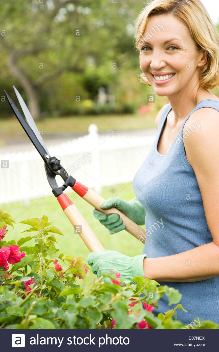 woman in the garden holding garden shears Stock Photo, Royalty Free