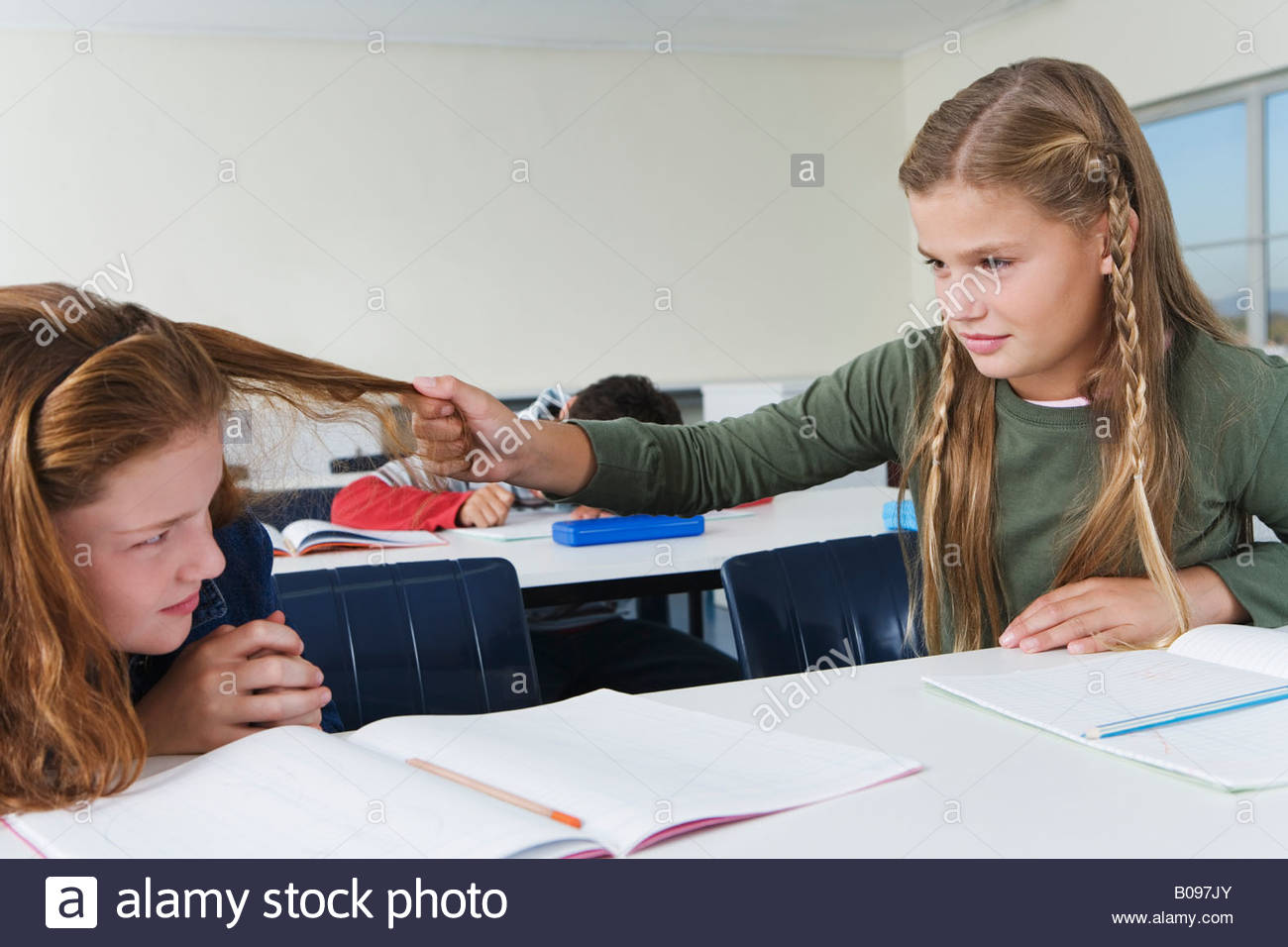 School girls (1013) in classroom, one girl pulling other girls hair