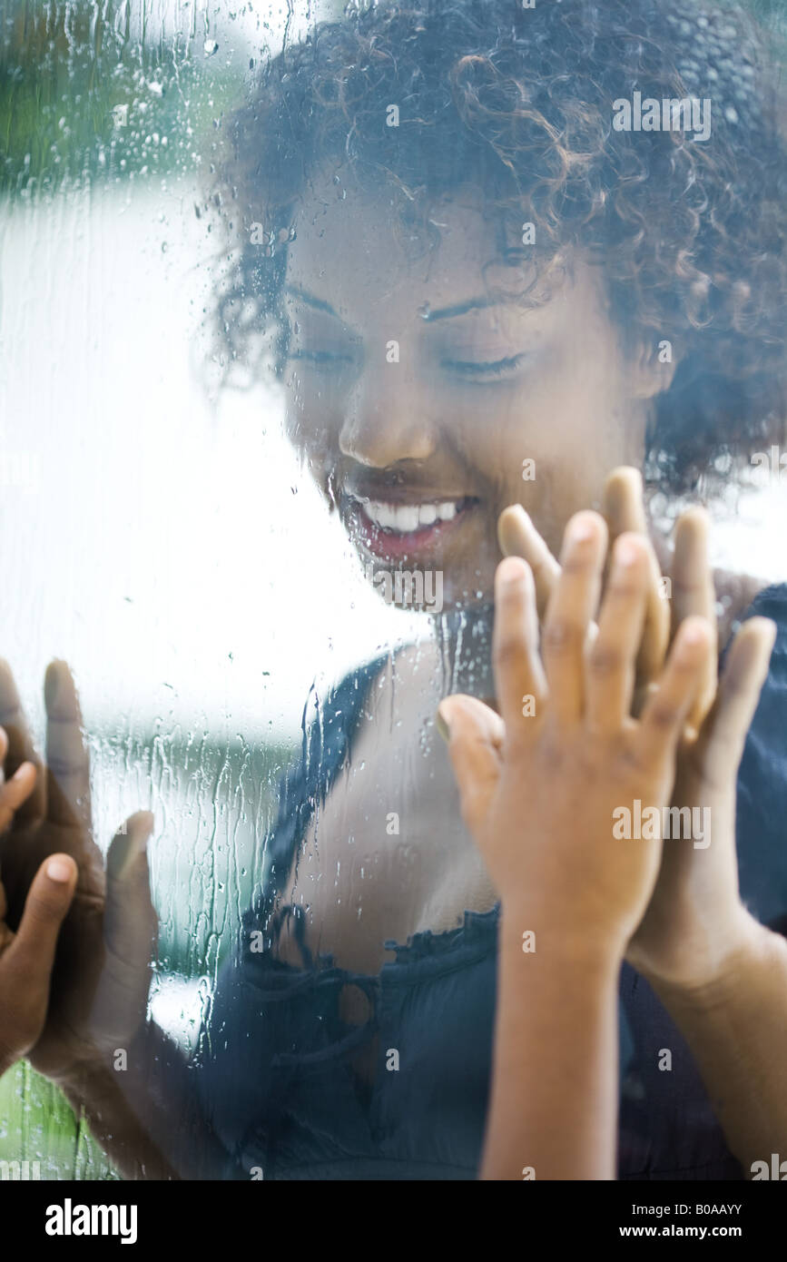 woman-looking-through-window-holding-her