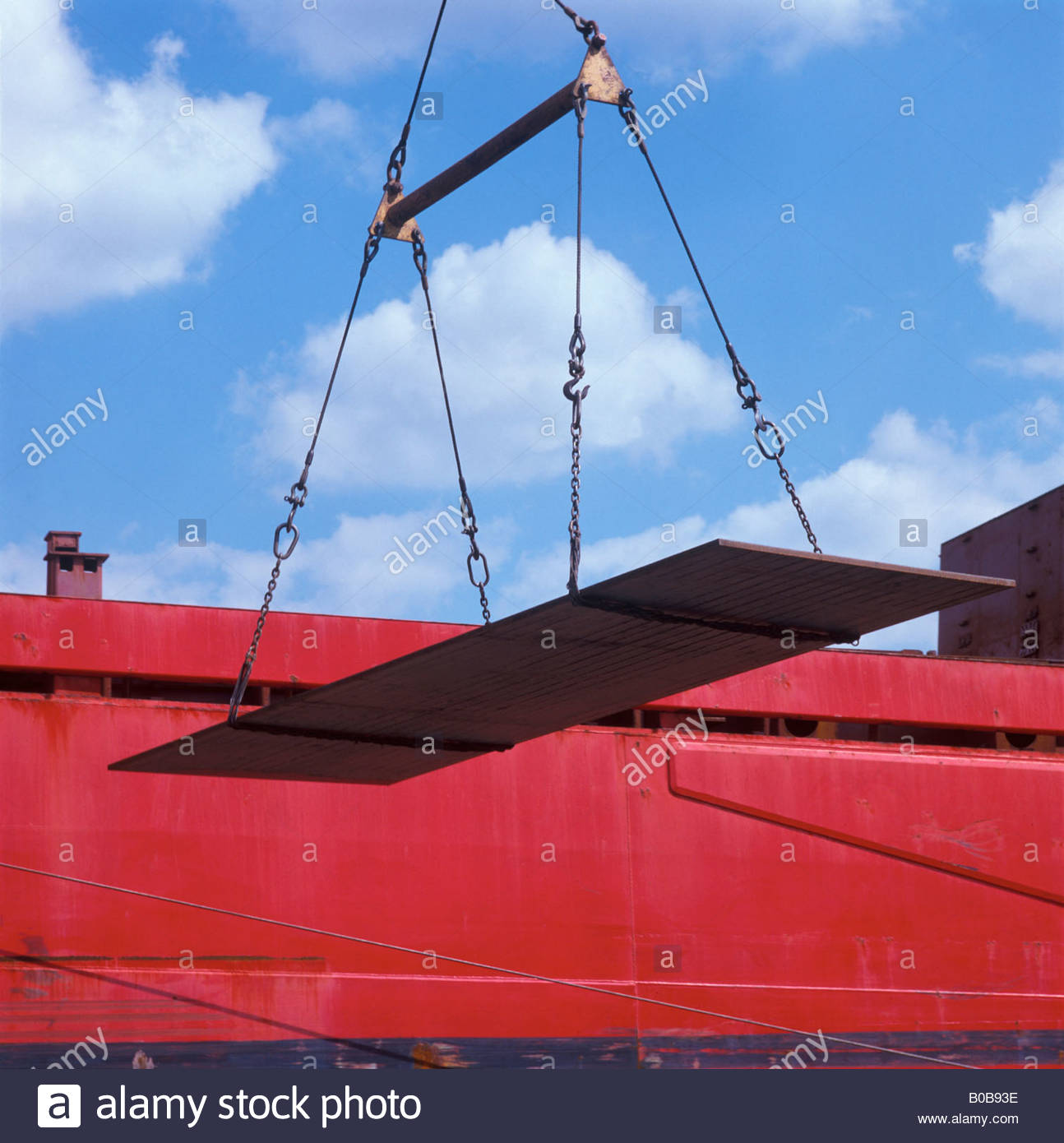 Crane unloading steel plate from ship Stock Photo, Royalty Free Image