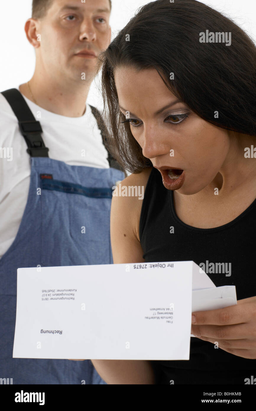 Download preview image - woman-shocked-appalled-at-the-bill-given-to-her-by-a-handyman-workman-B0HKMB