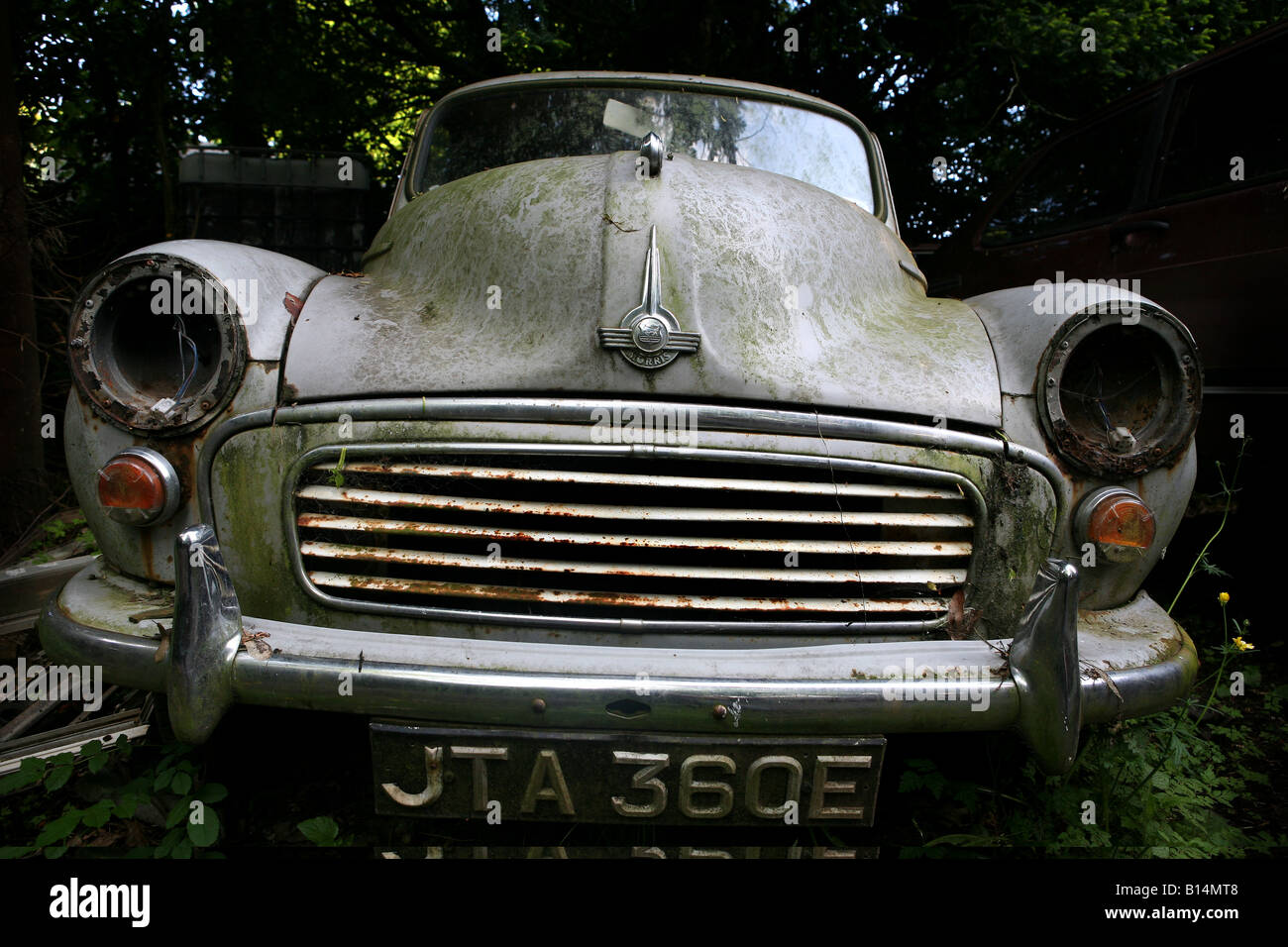 Abandoned Morris Minor in scrap yard Stock Photo, Royalty Free Image