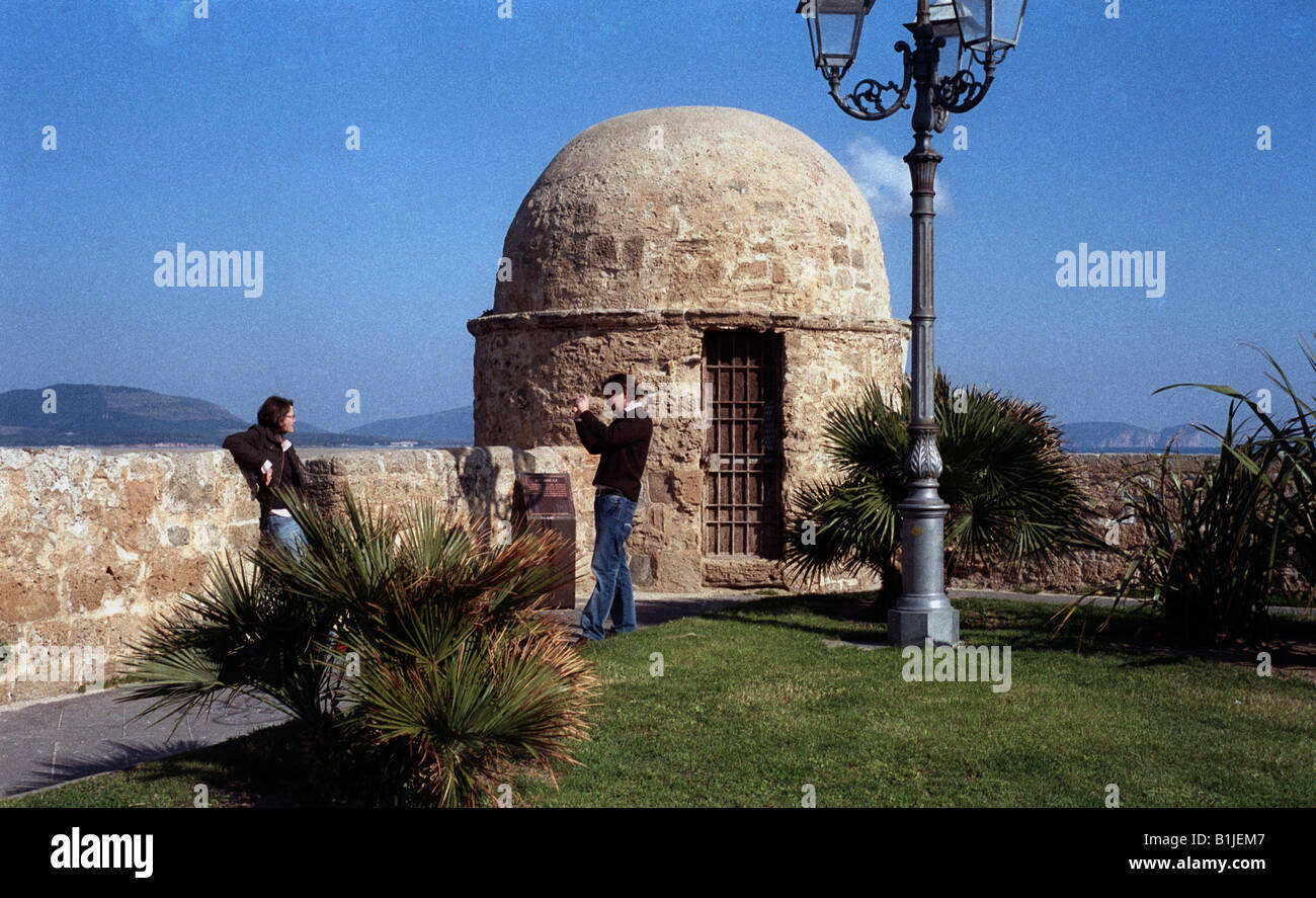 Italy Sardinia Alghero city walls with fortress dome two people one