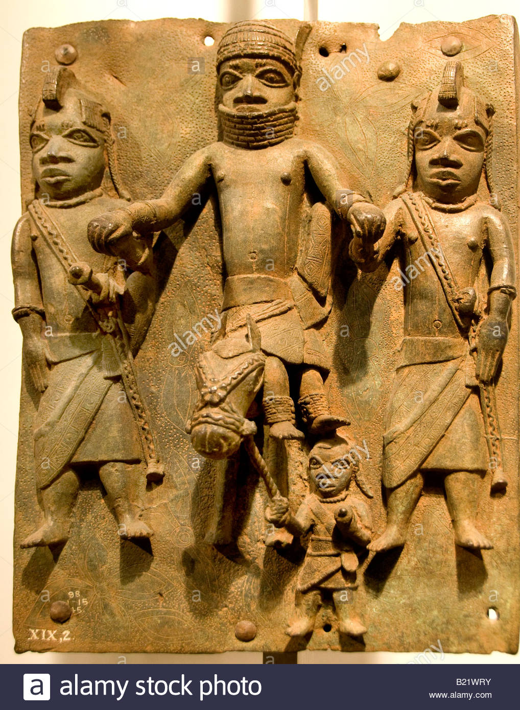 Bronze Brass plaque showing the Oba of Benin with attendants Edo Stock