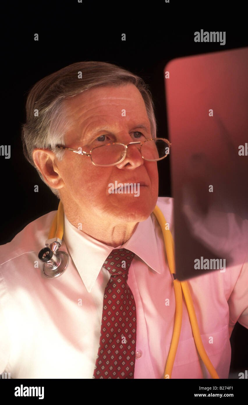 SENIOR MALE PHYSICIAN STUDYING X RAY HAND IMAGE Stock Photo - senior-male-physician-studying-x-ray-hand-image-B274F1