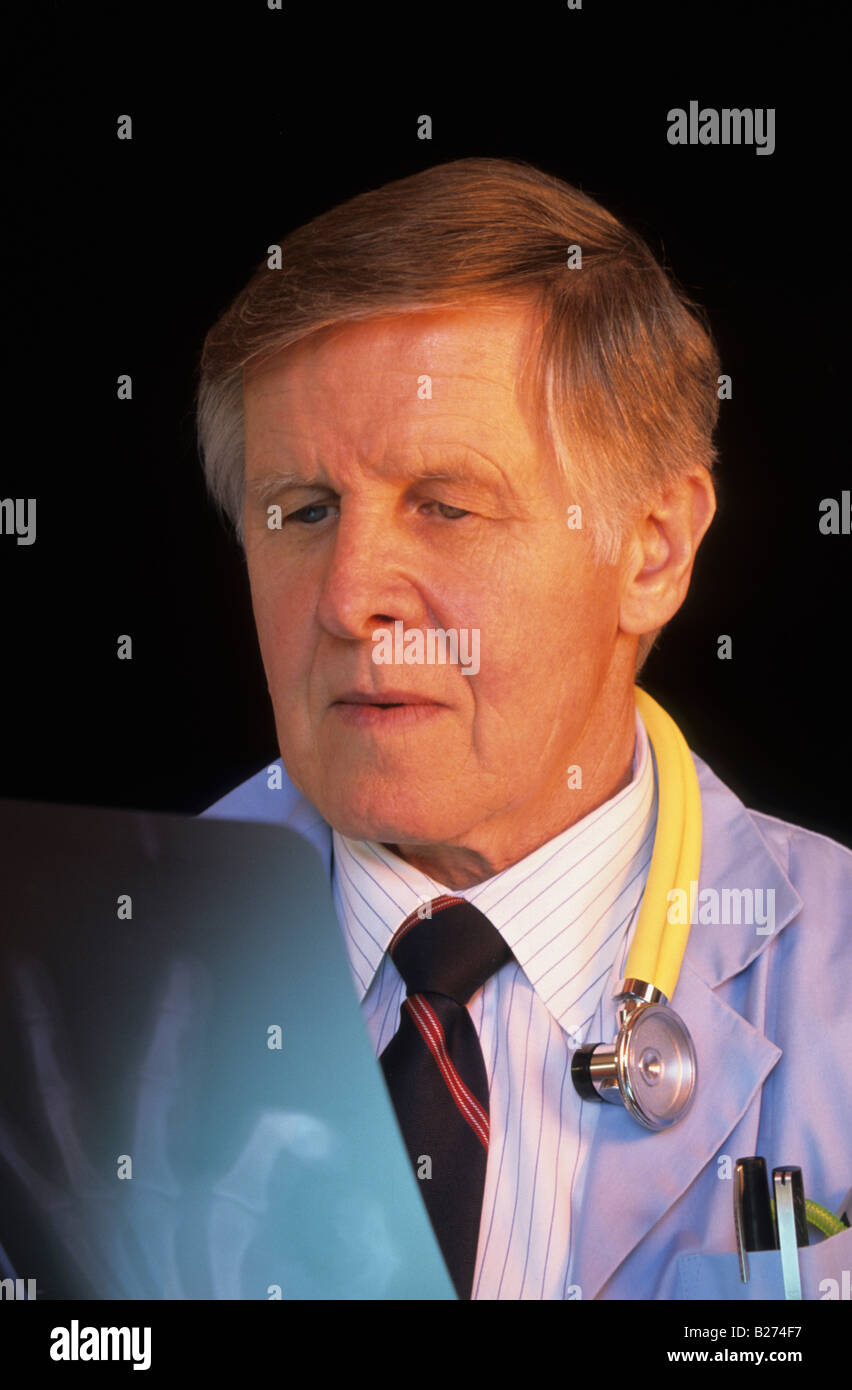 SENIOR MALE PHYSICIAN STUDYING X RAY HAND IMAGE Stock Photo - senior-male-physician-studying-x-ray-hand-image-B274F7