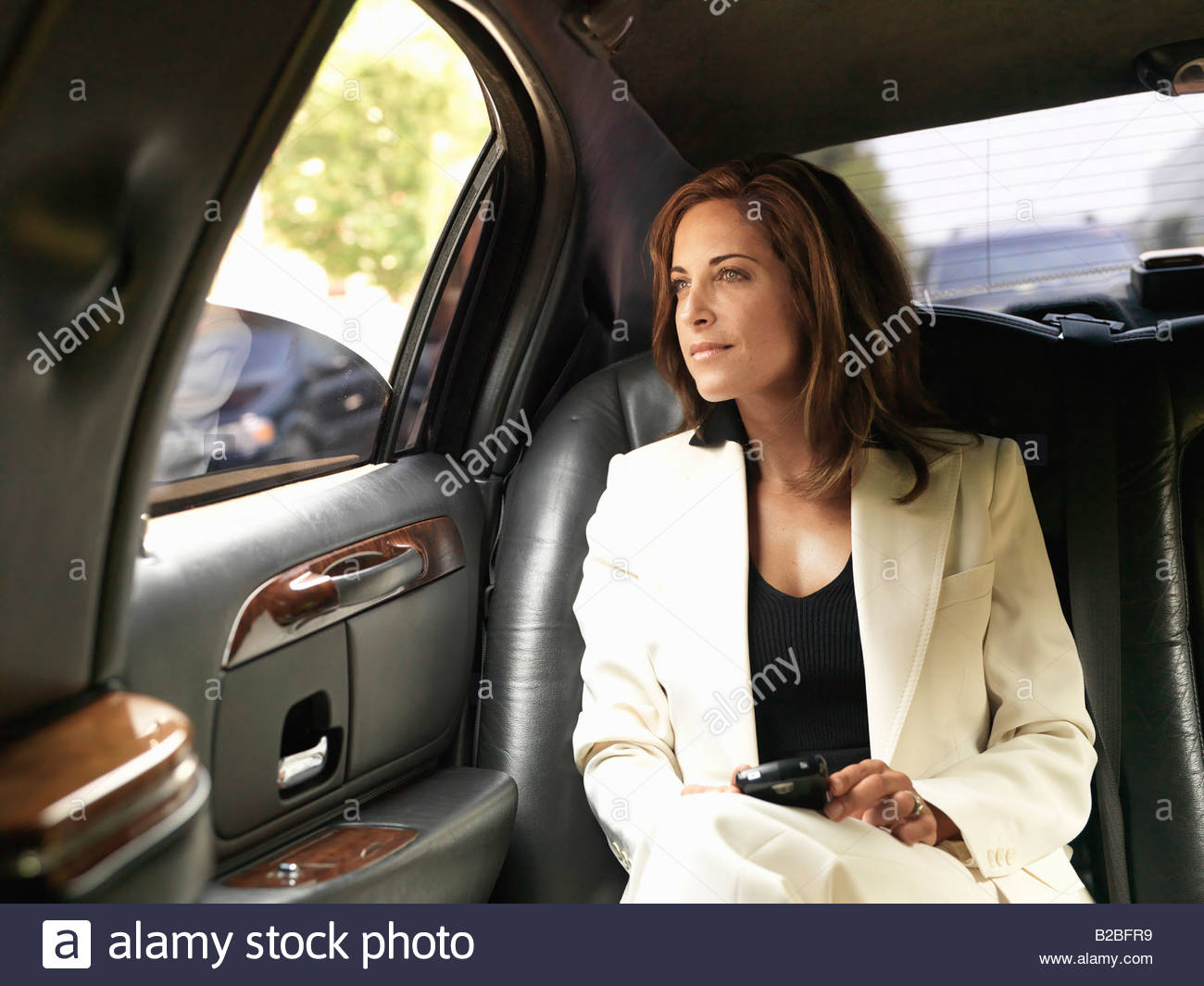 Businesswoman Next To Luxury Car Businesswoman In Backseat Of Car Stock Photo Royalty Free