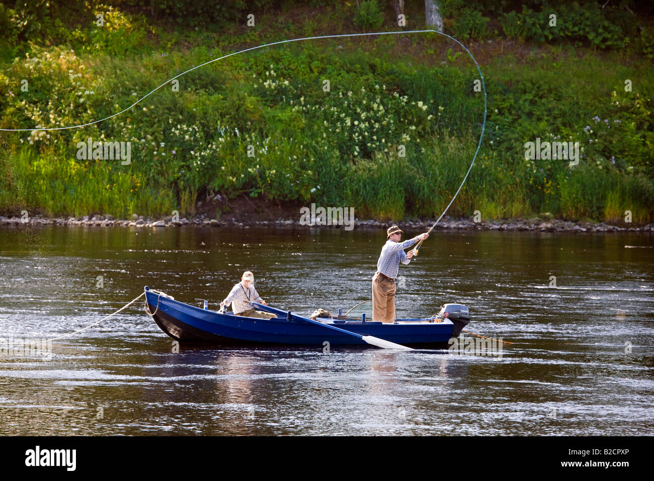 Boat fisherman Casting with Fly rod . Salmon Fishing on the River Tay