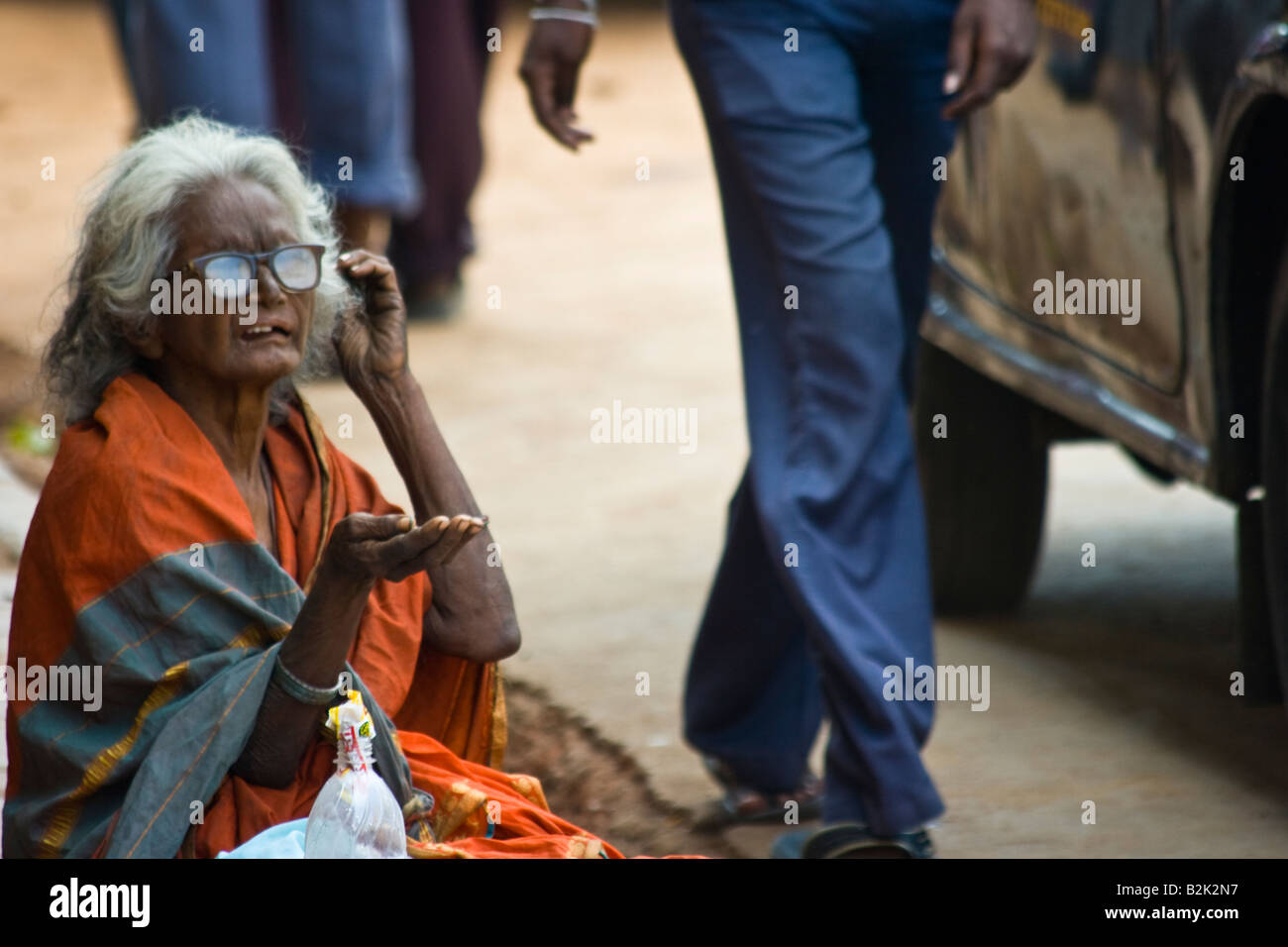 Old Homeless Woman Begging in the Streets of Mumbai India Old Homeless Woman Begging in the Streets of Mumbai India
