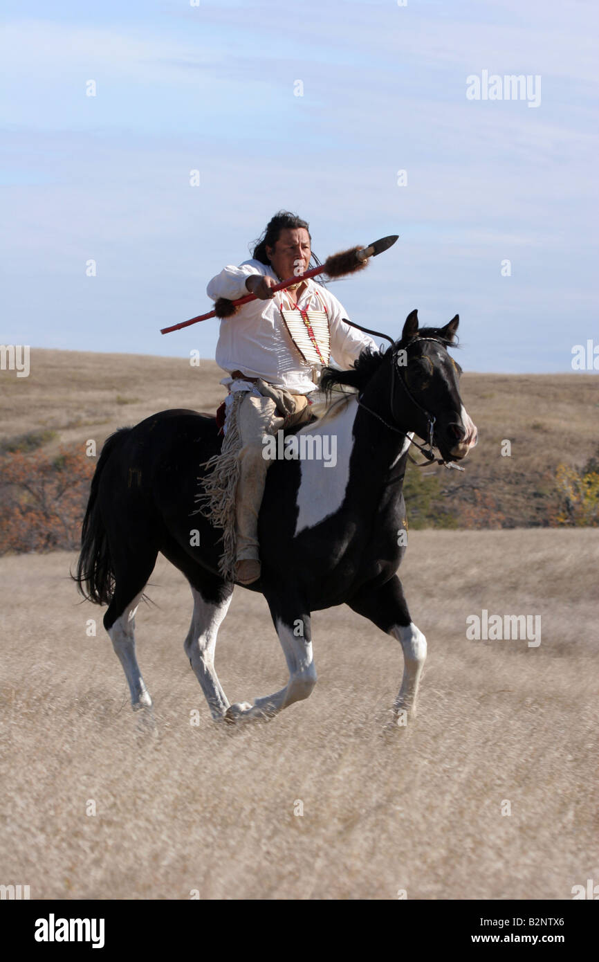 A Native American Sioux Indian on Horseback running with a spear in