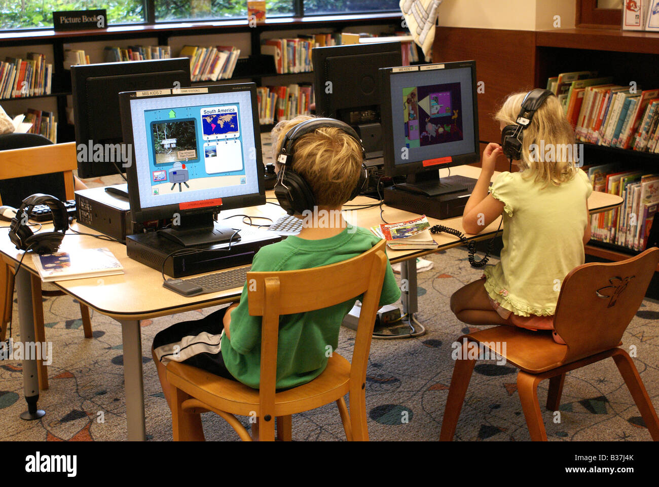 two children using computers in public library Stock Photo ...