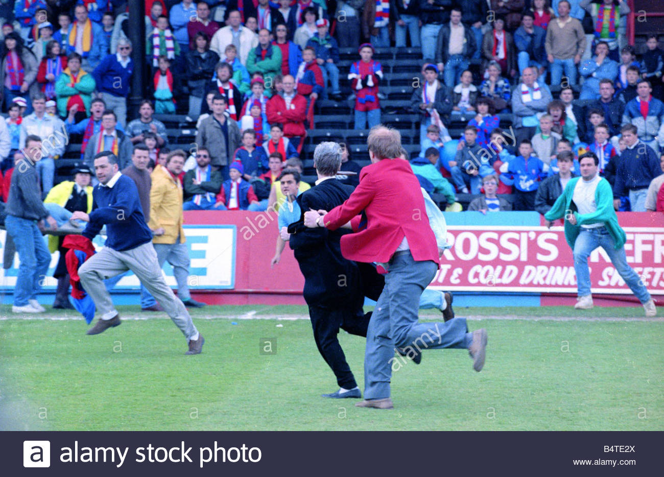 Fans fighting on the pitch at Selhurst Park after the match between