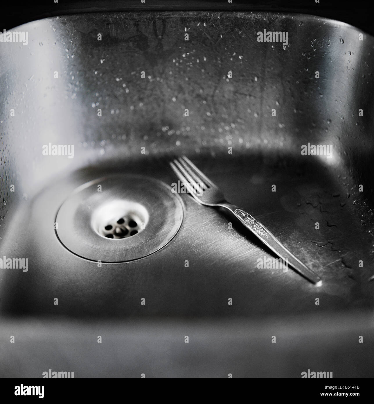 Close up of a fork in the kitchen sink Stock Photo, Royalty Free Close up of a fork in the kitchen sink Stock Photo, Royalty Free