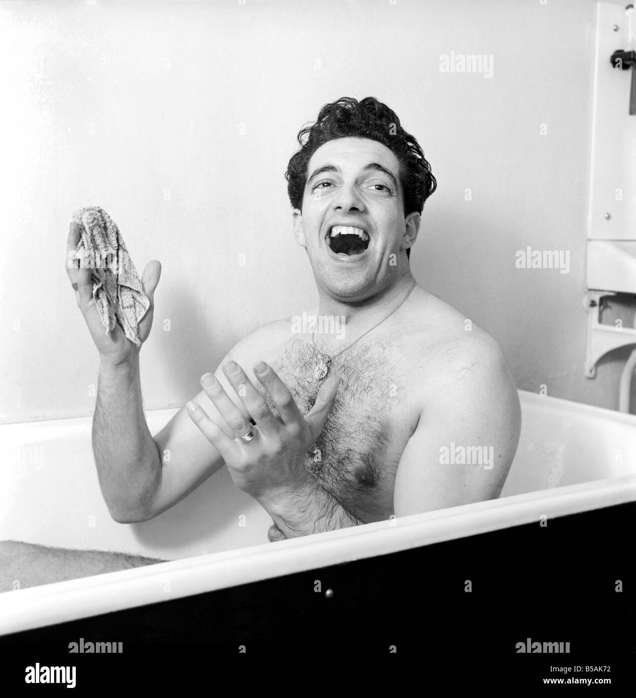 Singer Frankie Vaughan seen here singing in the bath at the family