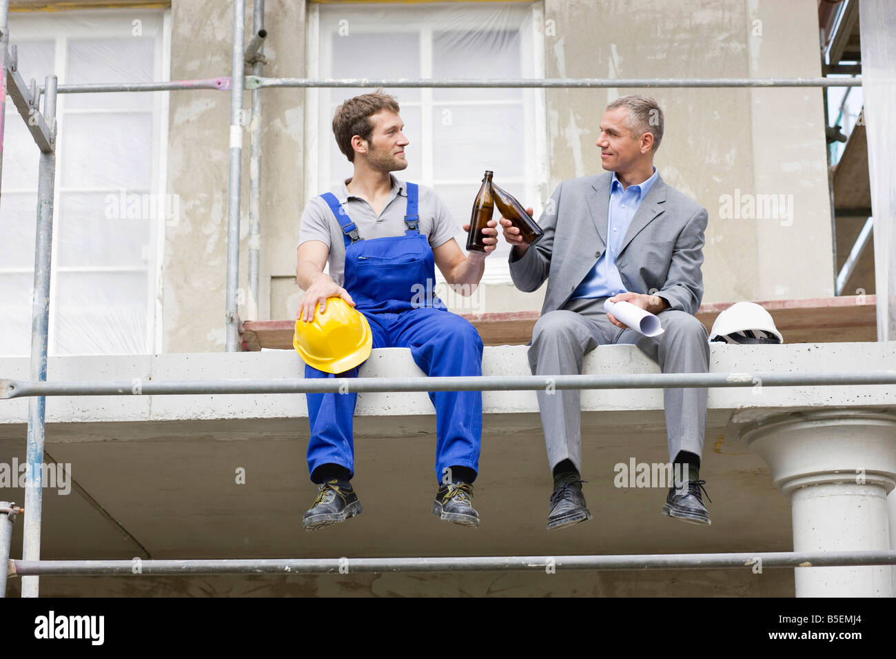 architect and construction worker on site, drinking beer stock architect and construction worker on site, drinking beer stock