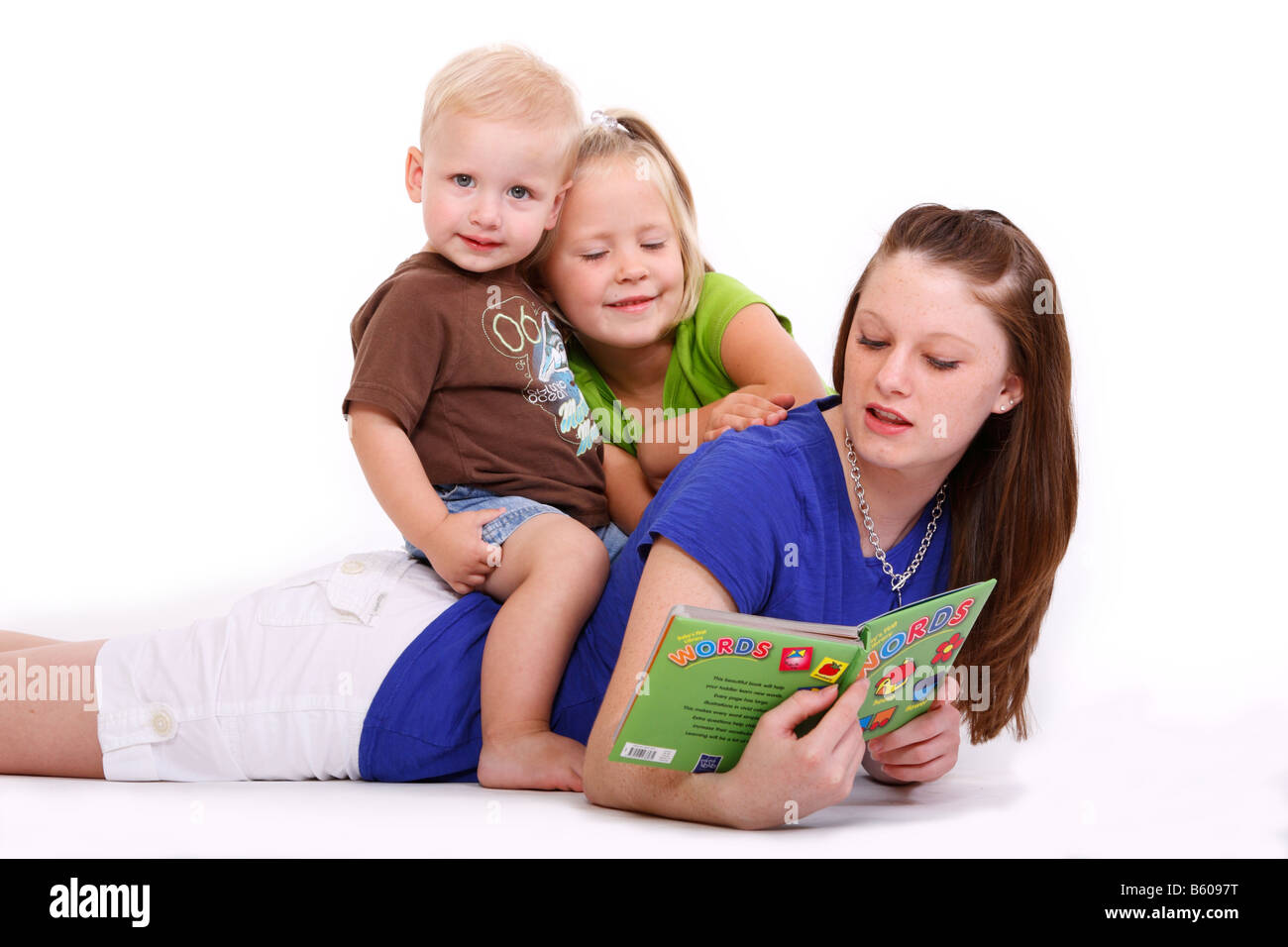 Worksheet Helping Kids To Read a teenage girl is helping two kids learn to read stock photo read